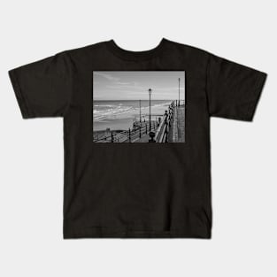 Concrete ramp down to the sandy beach in the coastal town of Cromer Kids T-Shirt